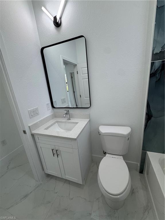 Full bathroom with vanity, a textured wall, a bath, light marble finish flooring, and a shower with curtain