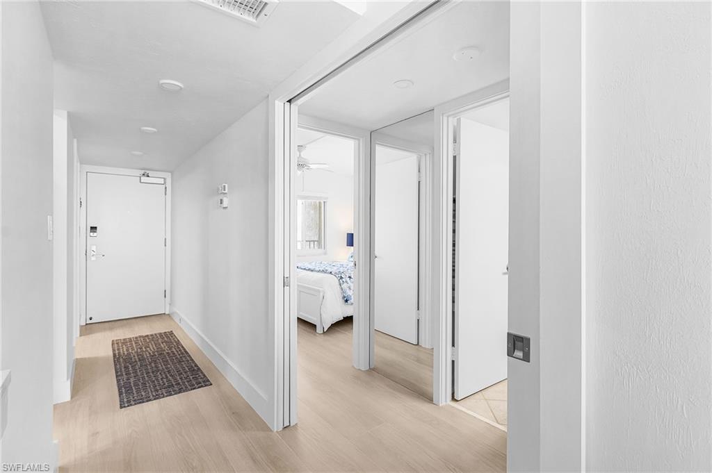 This space shows the guest suite with pocketing doors to allow guests privacy from bedroom to bathroom. By the way, there is a 2023 A/C unit with a brand-new Google thermostat ensures year-round comfort.