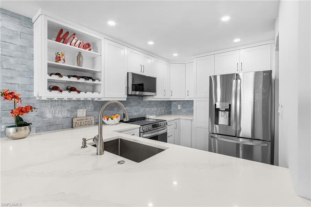 Stainless LG ThinQ Smart Appliances. Gorgeous backsplash and lots of storage in this kitchen.
