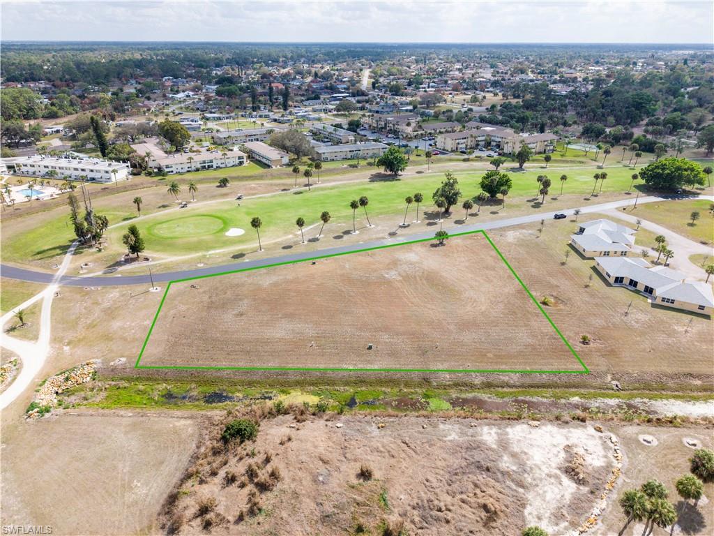 Aerial view of property and surrounding area with property parcel outlined