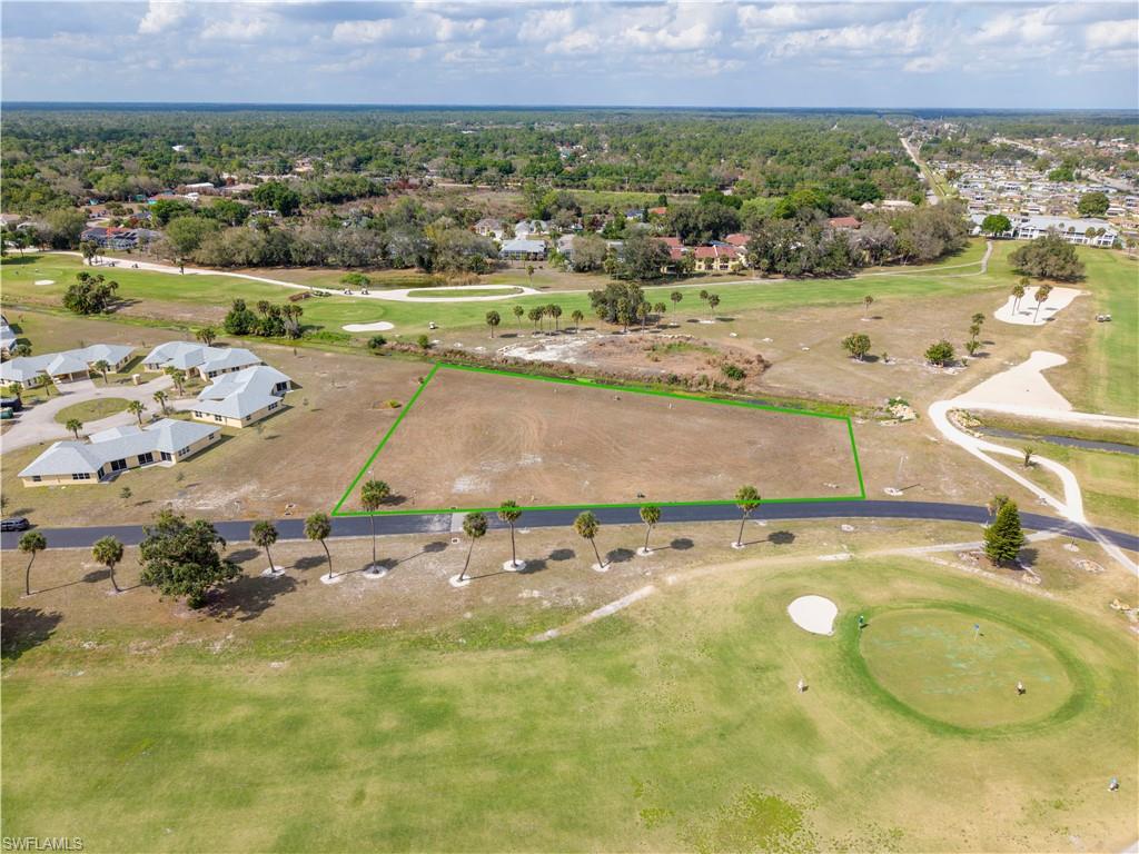 Aerial view of residential area featuring property parcel outlined and a local golf course