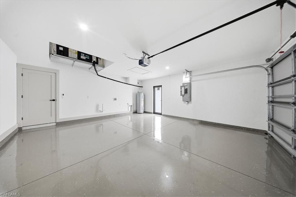 Garage featuring electric water heater and recessed lighting