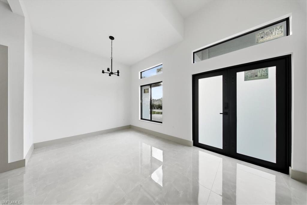 Foyer entrance featuring a high ceiling and french doors