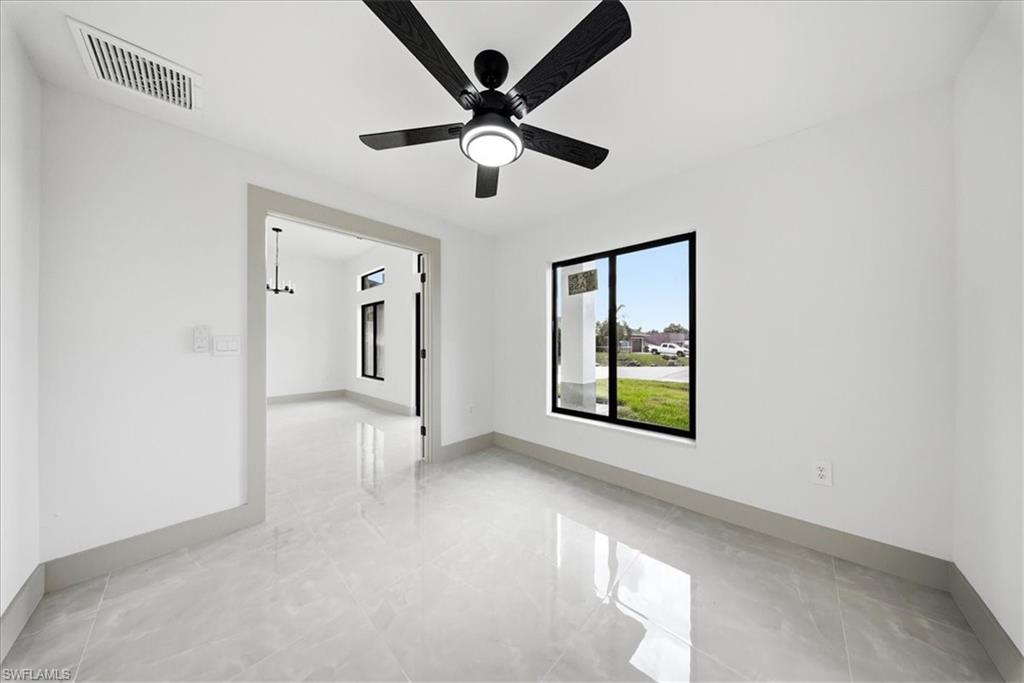 Spare room with baseboards and ceiling fan