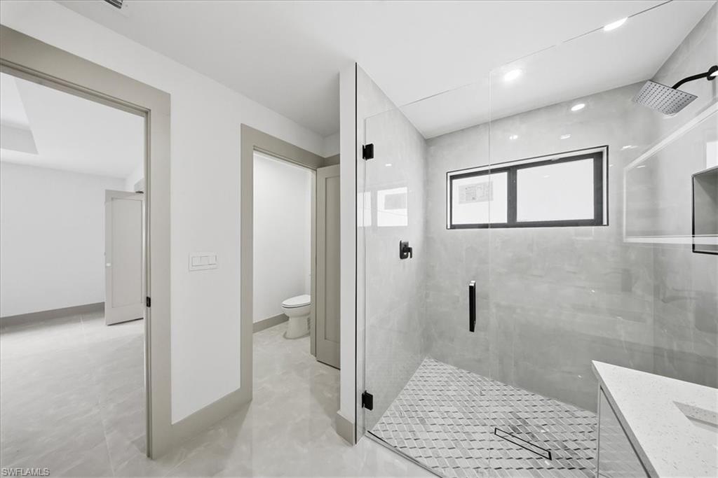 Full bathroom featuring a stall shower and vanity