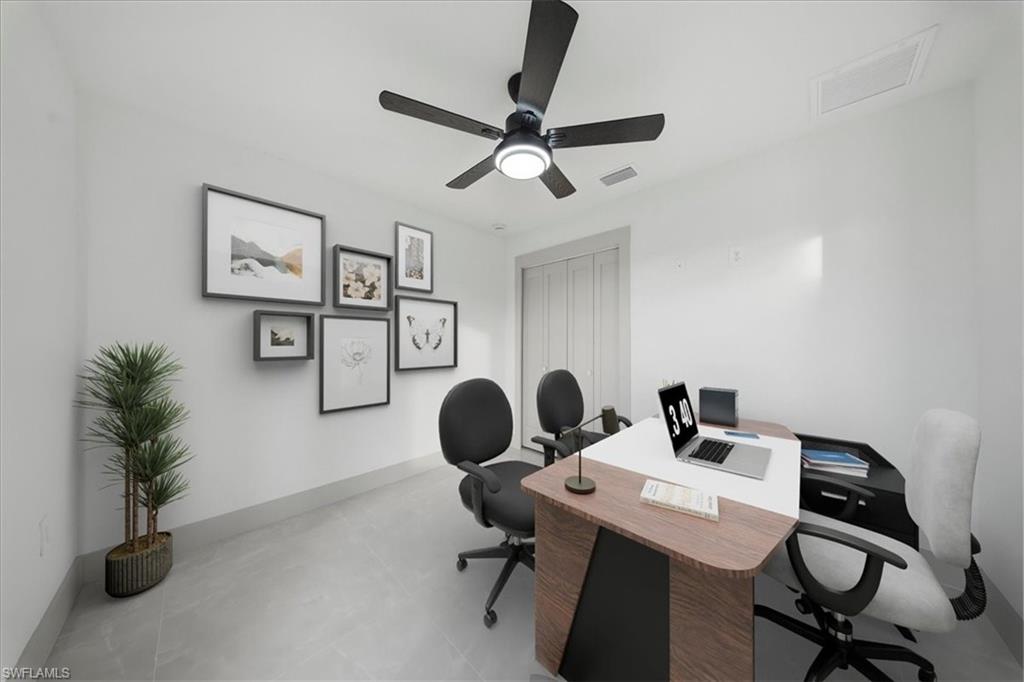 Office space featuring a ceiling fan and concrete flooring