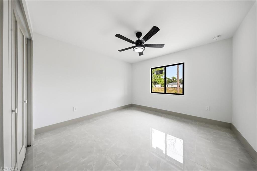 Unfurnished room featuring baseboards and a ceiling fan