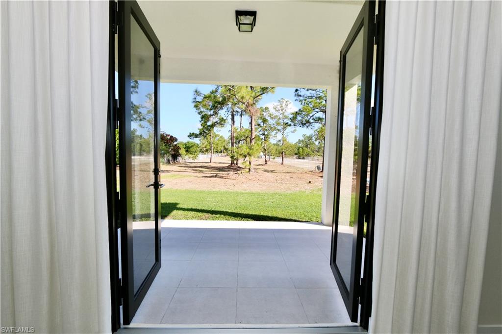 Doorway featuring tile patterned flooring