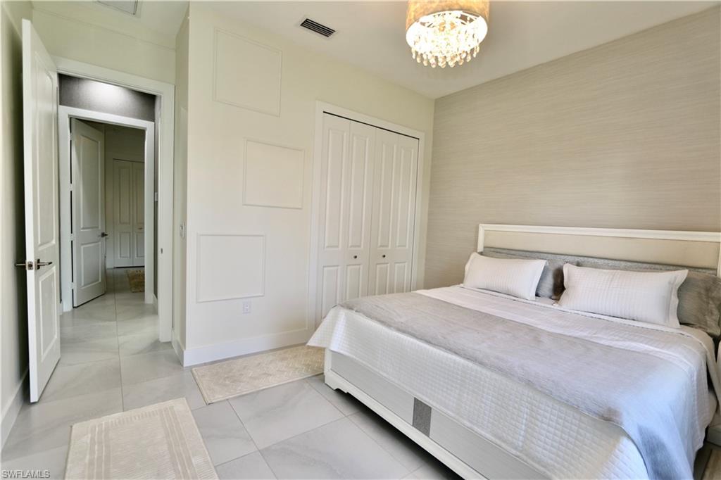 Bedroom with a chandelier and a closet