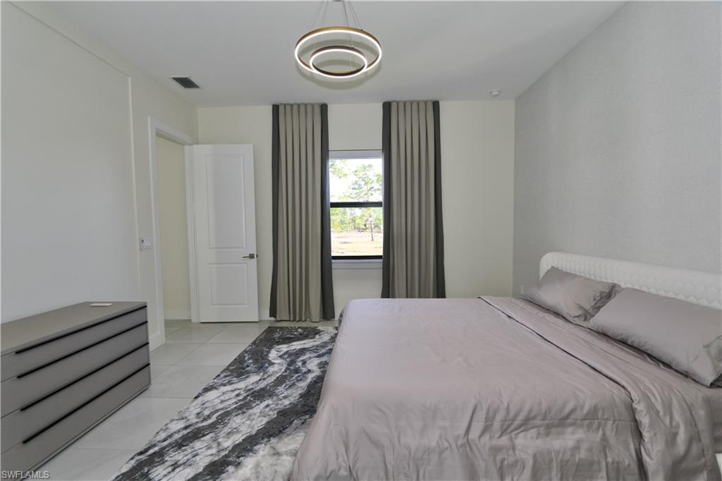 Bedroom with light tile patterned floors