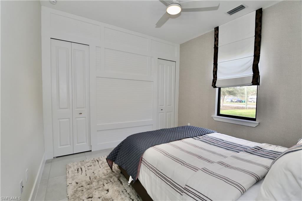 Bedroom featuring light tile patterned flooring and a ceiling fan