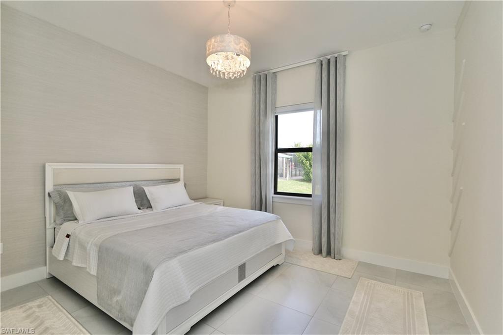 Bedroom featuring baseboards and hanging lights