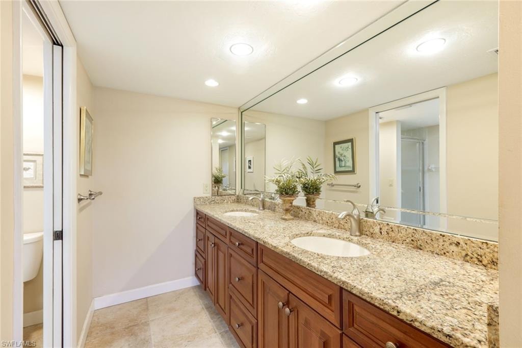 Raised Dual Sinks, Wood Cabinetry, Custom Mirrors, Medicine Cabinets, Tile Flooring