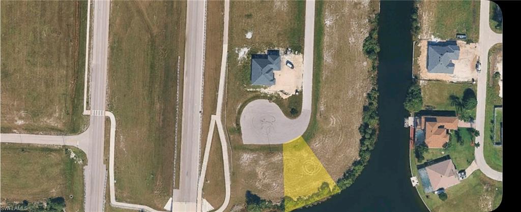 Aerial overview of property's location with a nearby body of water