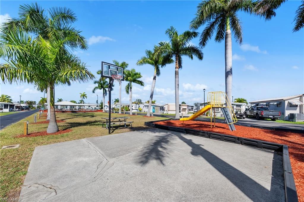 Communal playground with a residential view and a lawn