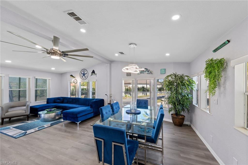 Dining room featuring wood finished floors, a ceiling fan, and recessed lighting
