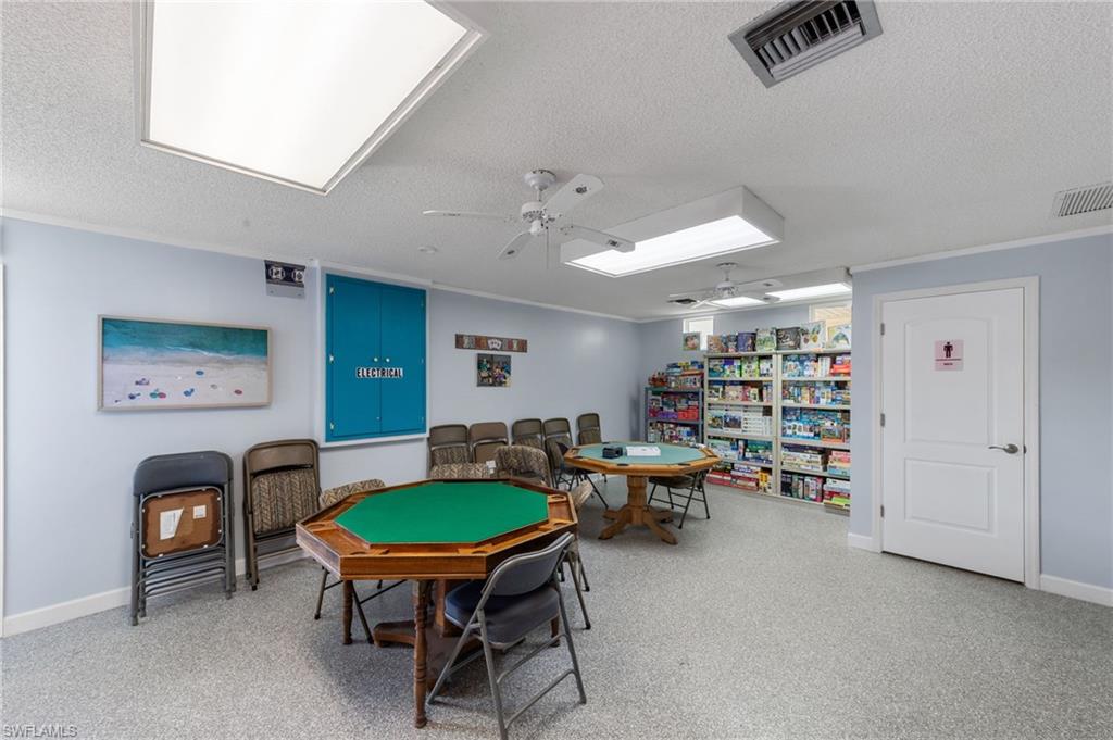 Rec room featuring a textured ceiling and ceiling fan