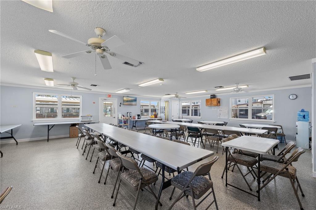 Dining space featuring a textured ceiling and baseboards