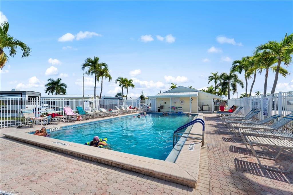 Community pool with a patio