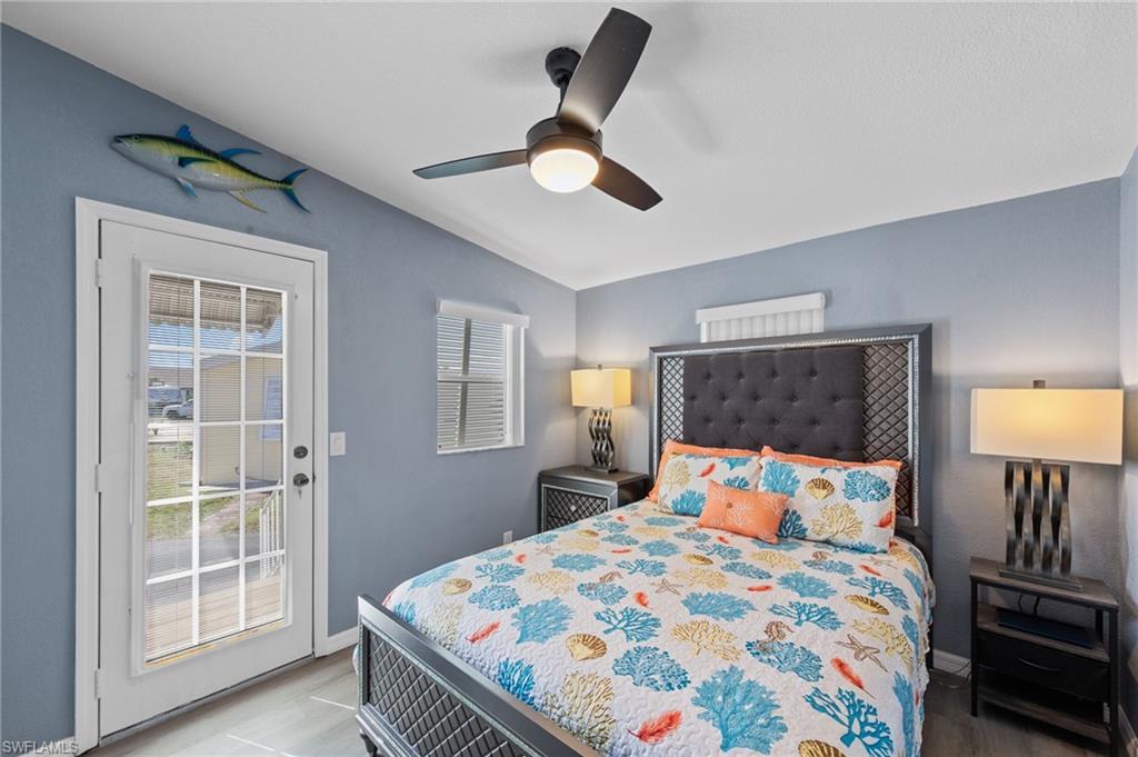 Bedroom featuring access to outside, lofted ceiling, and a ceiling fan
