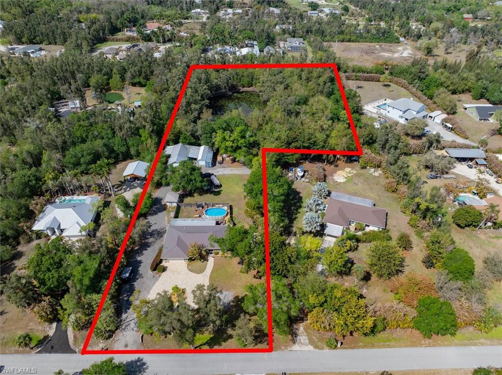 Aerial view of residential area featuring property boundaries highlighted