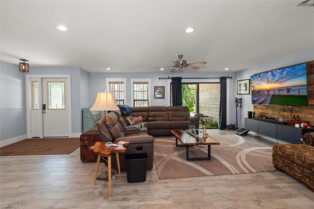 Living area featuring light wood-style flooring, recessed lighting, and a ceiling fan