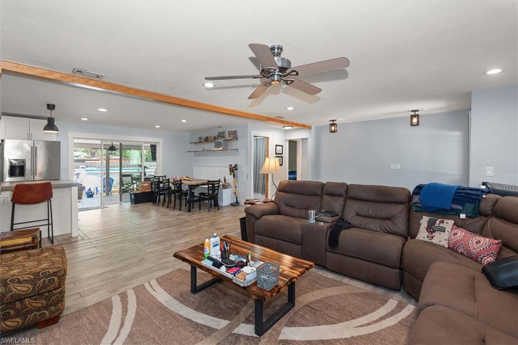 Living area featuring ceiling fan, light wood-style floors, and recessed lighting