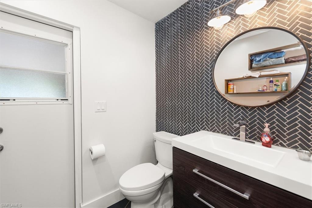 Bathroom featuring vanity and an accent wall
