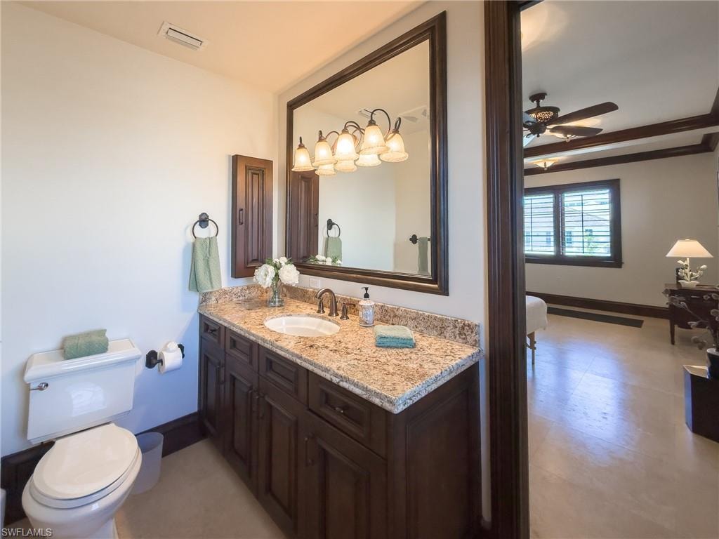 Ensuite bathroom featuring vanity and a ceiling fan