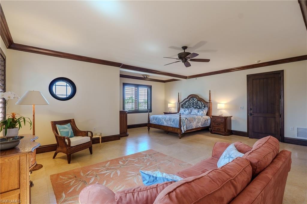 Bedroom featuring a ceiling fan and crown molding