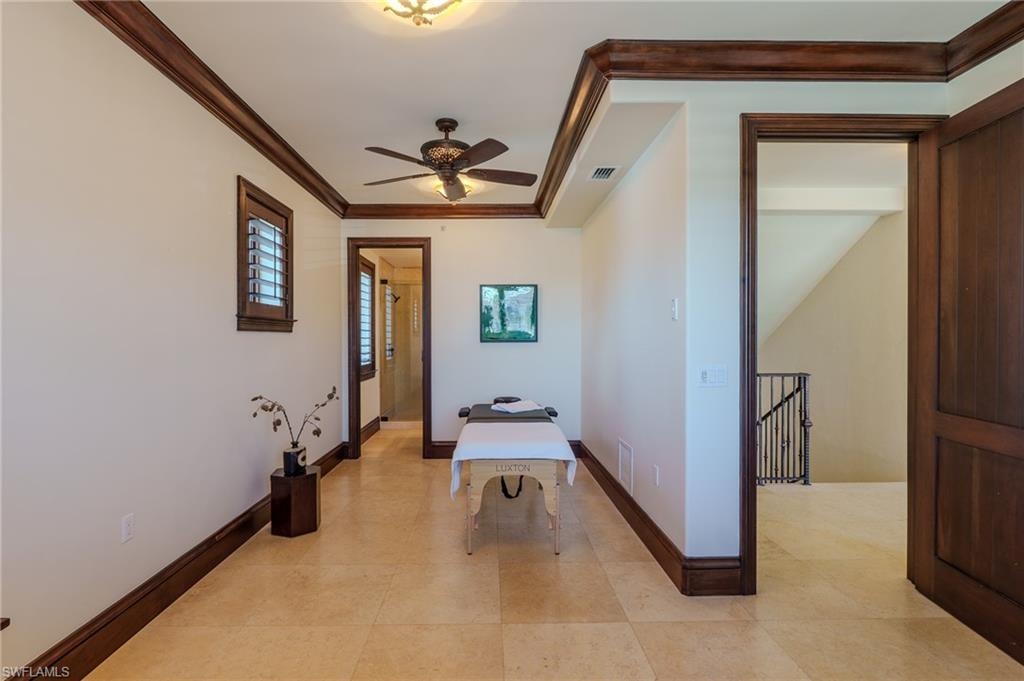 Hall with ornamental molding and an upstairs landing