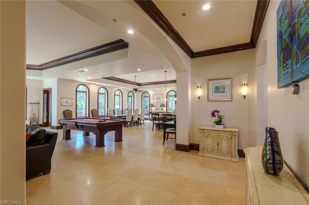 Game room with crown molding, pool table, a tray ceiling, recessed lighting, and arched walkways