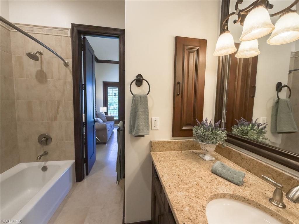 Ensuite bathroom with bathtub / shower combination and vanity