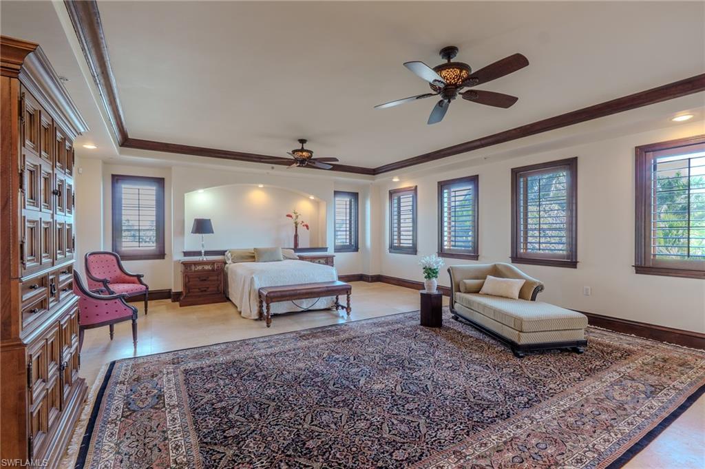 Bedroom with a raised ceiling, a ceiling fan, and recessed lighting