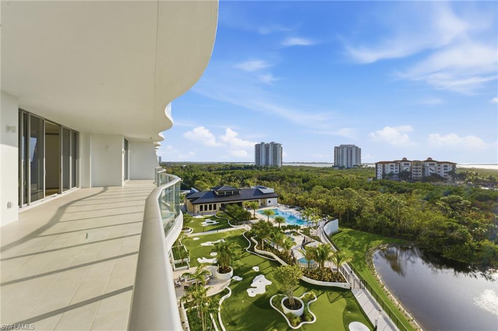 Balcony featuring a view of city, view of pool area, and a water view