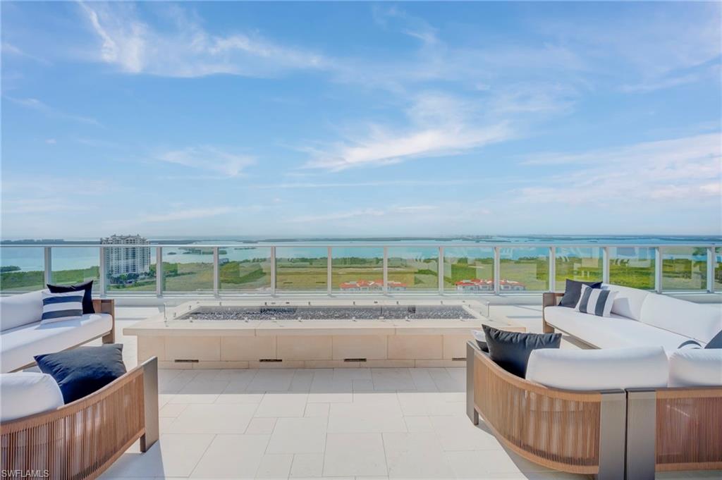 rooftop-  featuring an outdoor living space with a fire pit and a water view