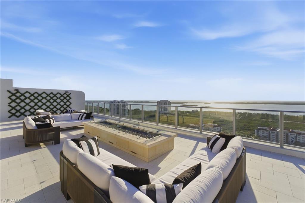 View of patio / terrace featuring an outdoor living space with a fire pit and a water view- ROOFTOP