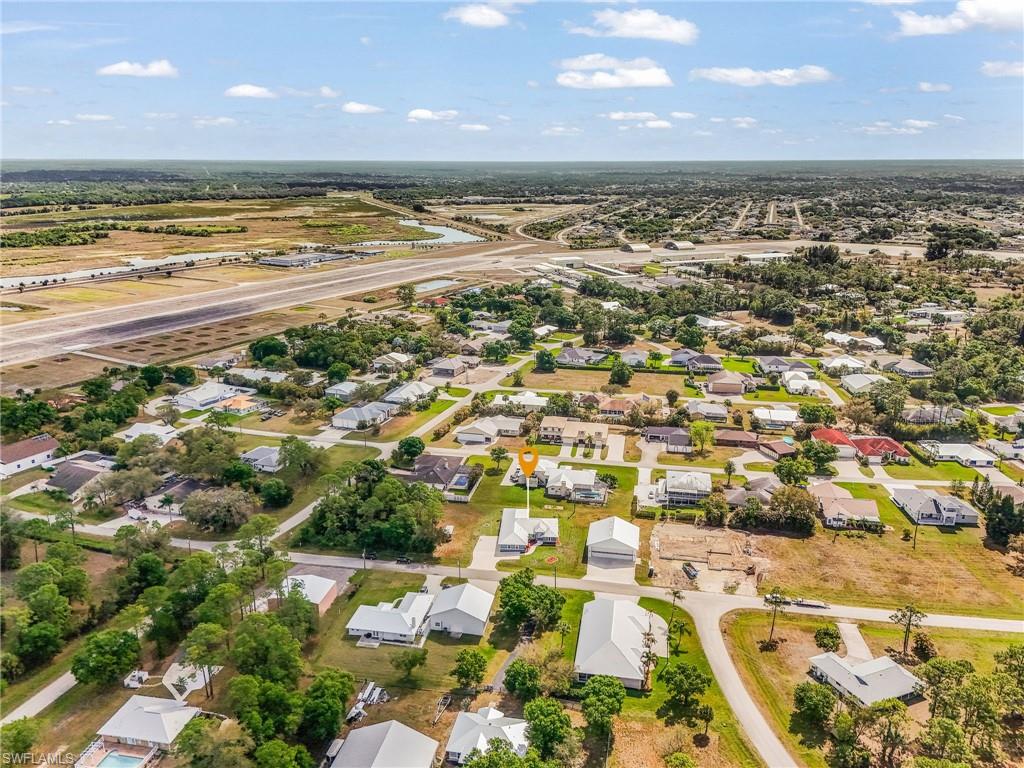 Aerial view of property and surrounding area featuring nearby RUNWAY