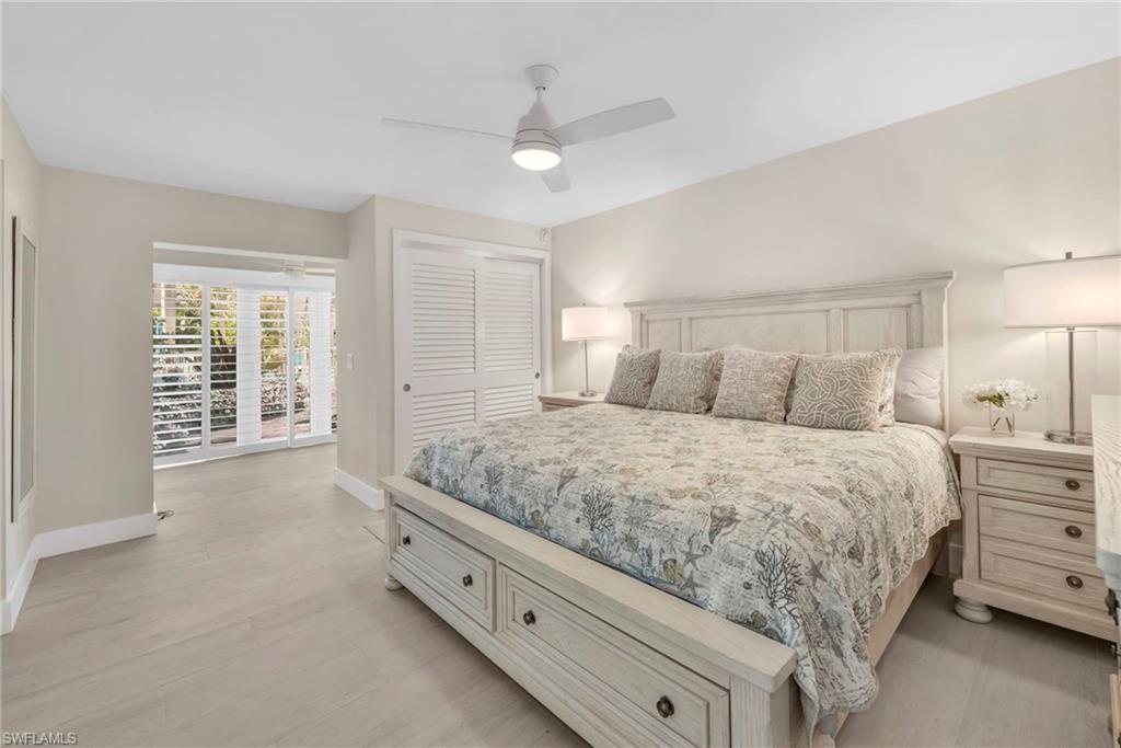 Bedroom featuring access to exterior, a ceiling fan, and a closet