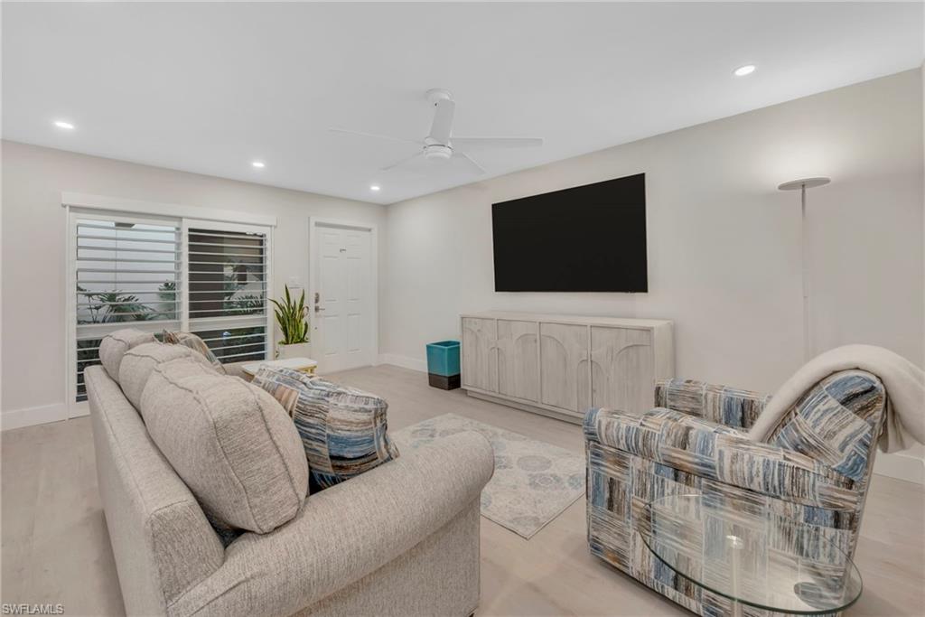 Living area featuring a ceiling fan, recessed lighting, and light wood-style floors