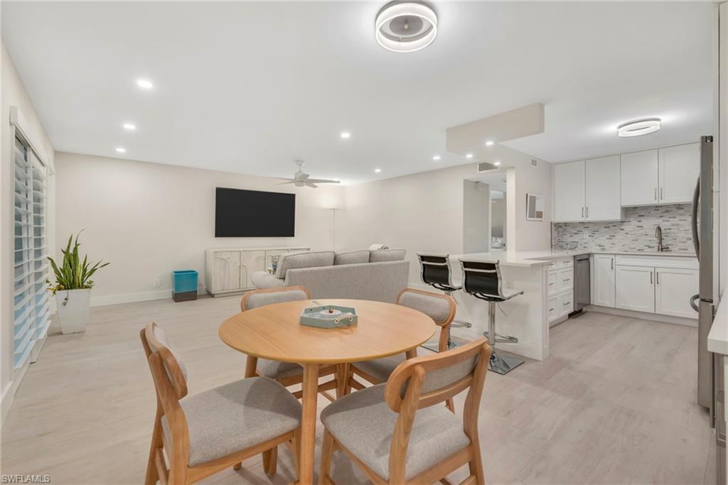 Dining area featuring light wood finished floors, recessed lighting, and ceiling fan