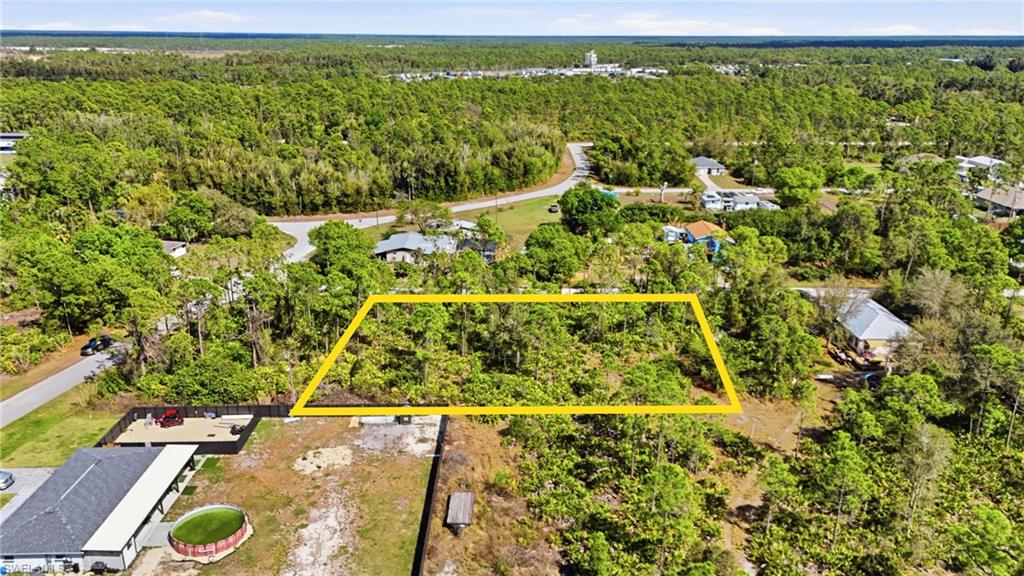 Aerial overview of property's location featuring a forest and property parcel outlined