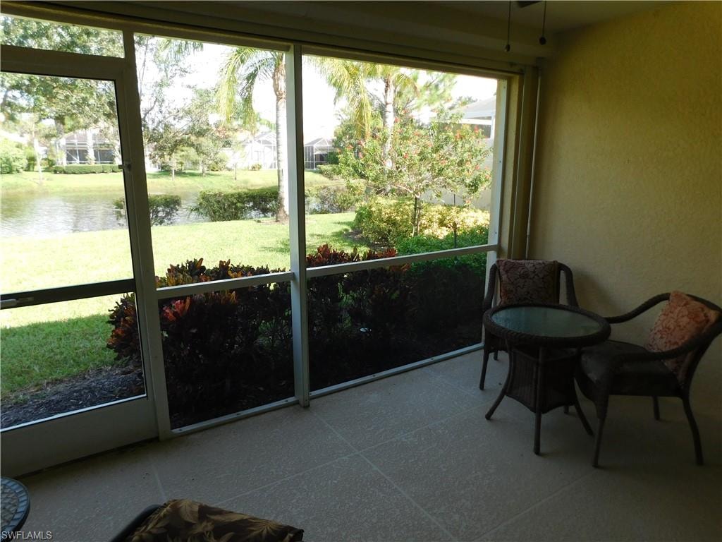 Sunroom with a lake view