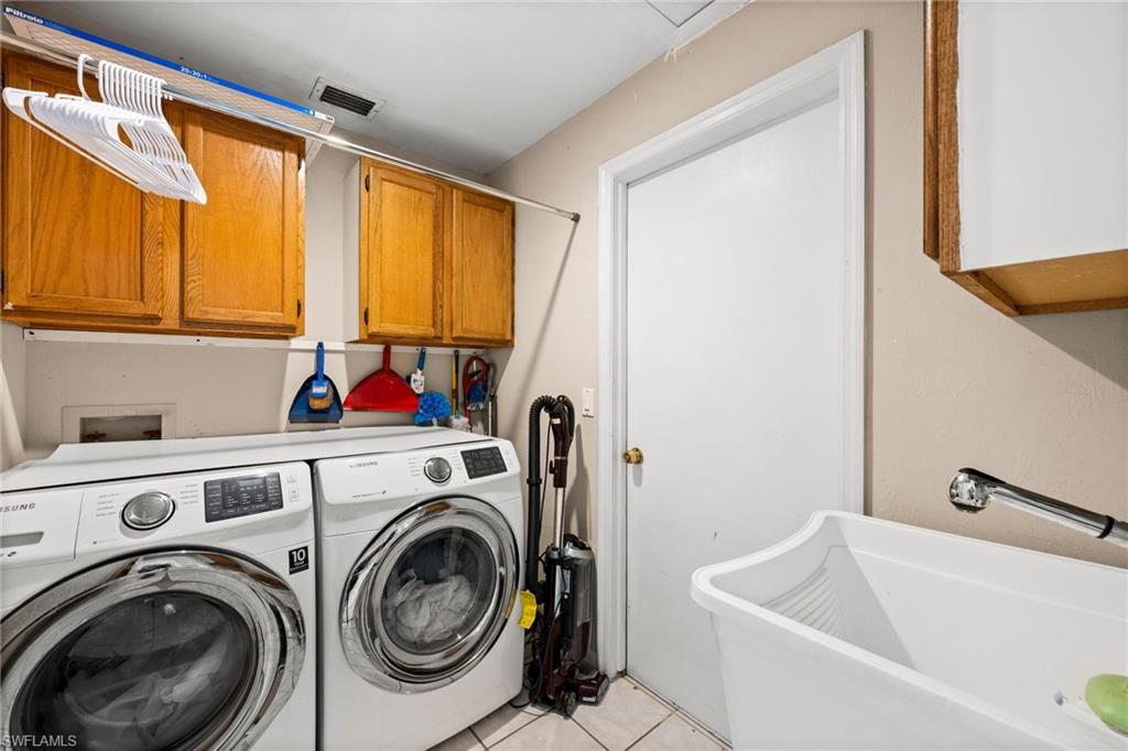 Laundry area featuring cabinet space, washer and dryer