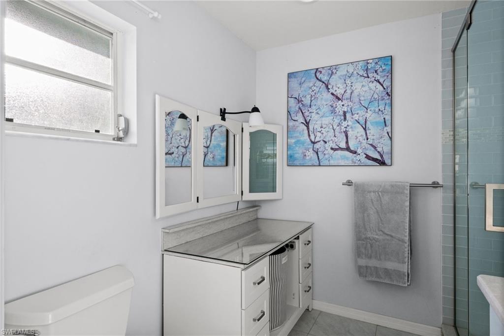 Bathroom featuring vanity, an enclosed shower