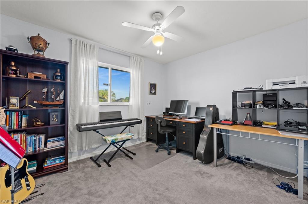 Office featuring light carpet and a ceiling fan
