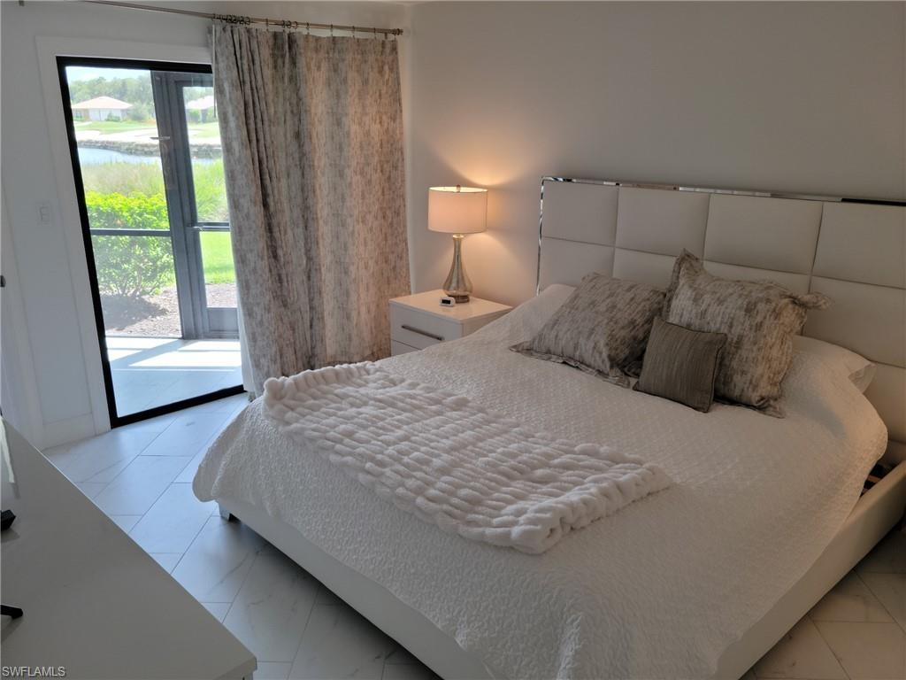 Owner's suite with King bed, sliders out to lanai, tile floors.