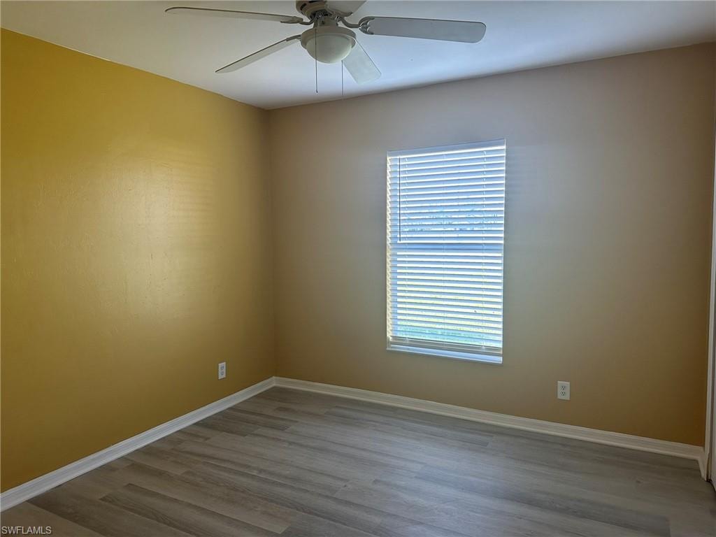 Spare room featuring light wood-style floors and ceiling fan