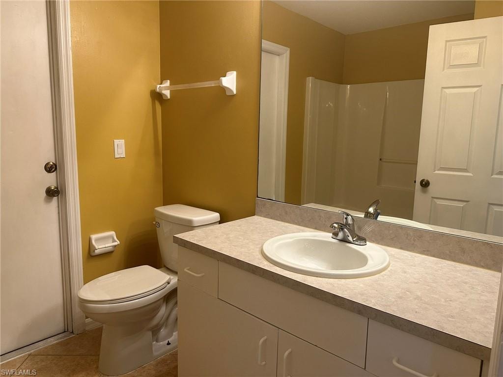 Bathroom featuring vanity, a shower, and light tile patterned floors