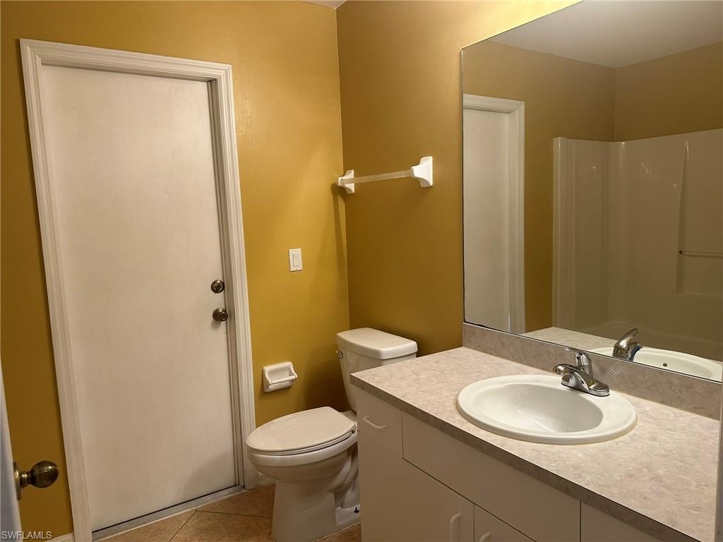 Full bathroom featuring vanity, light tile patterned floors, a tub, and a shower